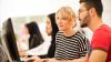 Man and woman looking at a computer screen